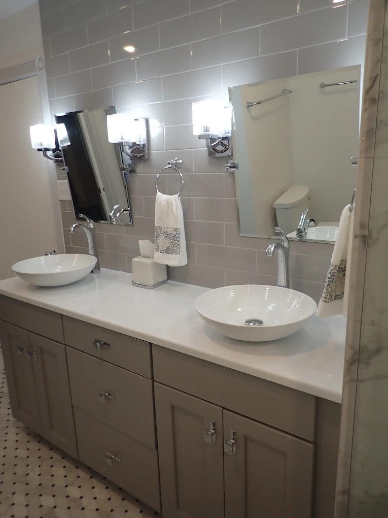 Double bathroom vanity with white vessel sinks, wall-mounted faucets, and rectangular mirrors